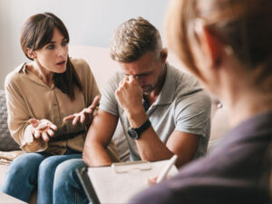 Distressed man and woman engage in couple's therapy.